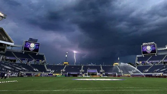 Lightning strikes near the Orlando Citrus Bowl as a severe weather warning forces the evacuation of the stands before the start of the Orlando City against FC Dallas game, in Orlando, Fla., on Saturday, July 11, 2015